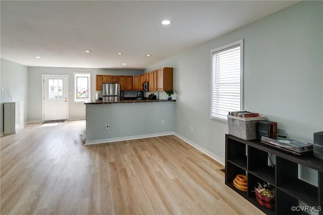 3107 Q St, Richmond, VA 23223 - kitchen with stainless steel appliances, brown cabinetry, light wood finished floors, a peninsula, and recessed lighting