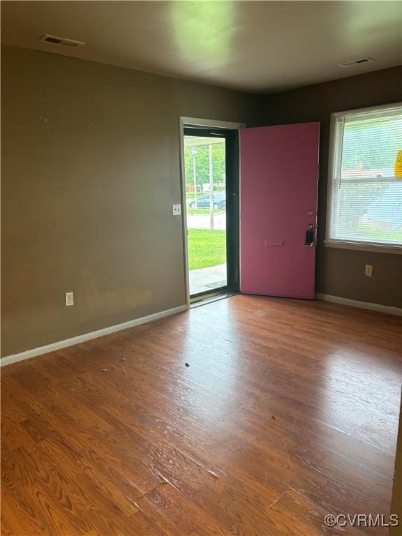 609 Carter St, Petersburg, VA 23803 - unfurnished room featuring healthy amount of natural light, baseboards, and wood finished floors