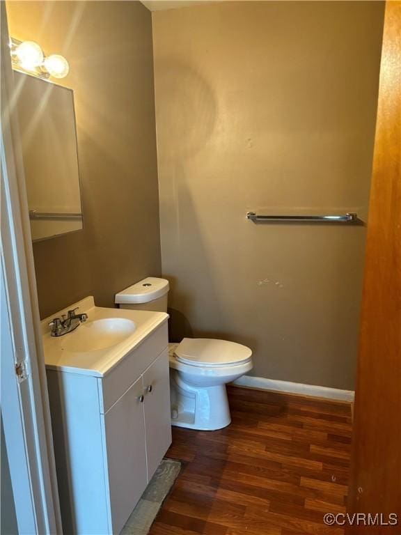 609 Carter St, Petersburg, VA 23803 - bathroom with wood finished floors, toilet, vanity, and baseboards