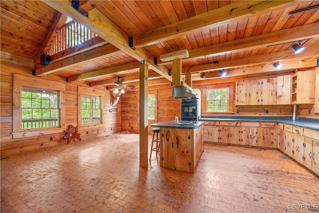 10 N River Ct, Cartersville, VA 23027 - kitchen with wood ceiling with exposed beams, light brown cabinets, wood walls, brick patterned flooring, and healthy amount of natural light
