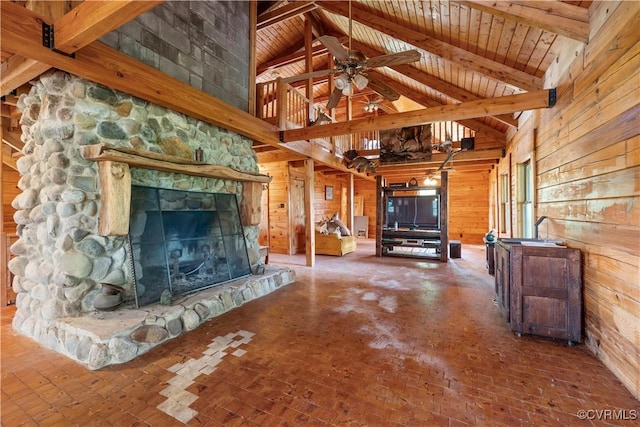 10 N River Ct, Cartersville, VA 23027 - unfurnished living room featuring wooden walls, ceiling fan, beam ceiling, a stone fireplace, and high vaulted ceiling