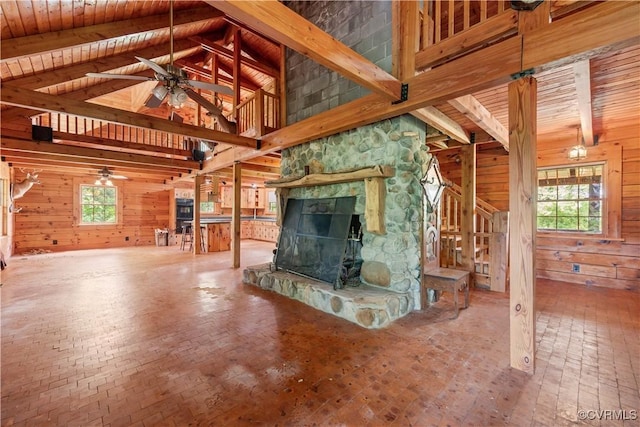10 N River Ct, Cartersville, VA 23027 - unfurnished living room featuring wood walls, a ceiling fan, wood ceiling with exposed beams, a fireplace, and stairs