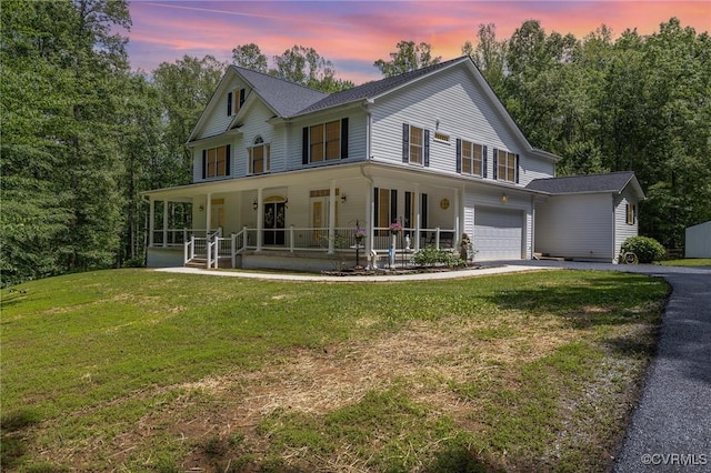 160 Walnut Ridge Dr, Stafford, VA 22556 - farmhouse featuring an attached garage, covered porch, asphalt driveway, and a front lawn