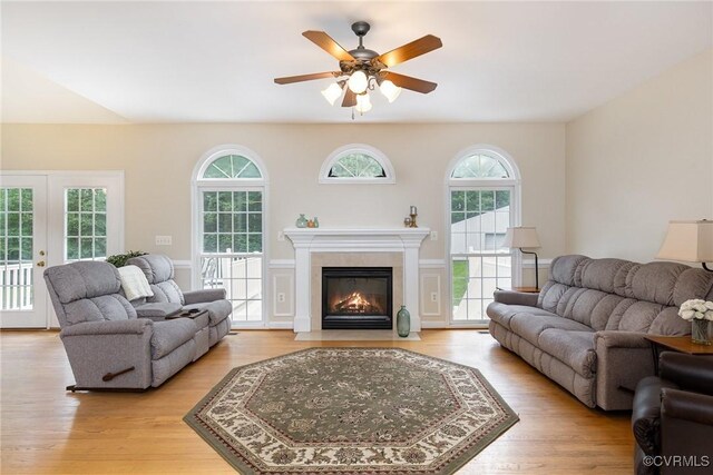 160 Walnut Ridge Dr, Stafford, VA 22556 - living room with light wood finished floors, a ceiling fan, a fireplace with flush hearth, and french doors