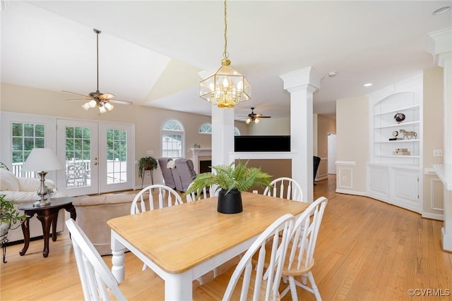 160 Walnut Ridge Dr, Stafford, VA 22556 - dining space with ceiling fan, decorative columns, light wood-style flooring, built in shelves, and a chandelier