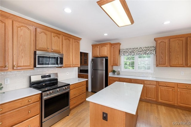 160 Walnut Ridge Dr, Stafford, VA 22556 - kitchen with appliances with stainless steel finishes, light countertops, decorative backsplash, a center island, and recessed lighting