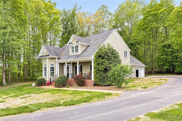 1905 Hope Meadow Way, Powhatan, VA 23139 - cape cod-style house featuring covered porch, asphalt driveway, a front yard, a shingled roof, and an attached garage
