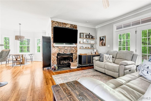 1905 Hope Meadow Way, Powhatan, VA 23139 - living room featuring crown molding, light wood-style flooring, a fireplace, and baseboards
