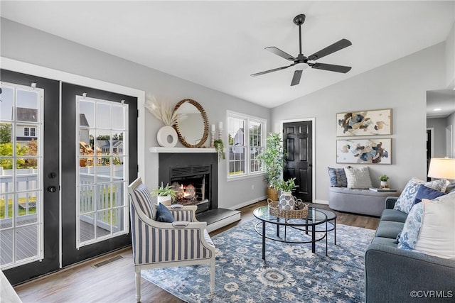 2505 Winston Ct, Glen Allen, VA 23060 - living room featuring lofted ceiling, wood finished floors, a ceiling fan, a warm lit fireplace, and baseboards