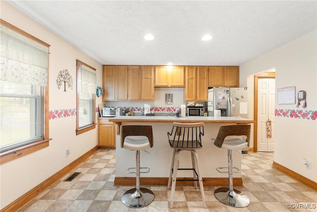 17 Brougham Rd, Fluvanna, VA 22963 - kitchen featuring appliances with stainless steel finishes, light floors, baseboards, a kitchen breakfast bar, and recessed lighting
