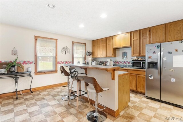 17 Brougham Rd, Fluvanna, VA 22963 - kitchen with appliances with stainless steel finishes, light floors, a kitchen breakfast bar, recessed lighting, and baseboards