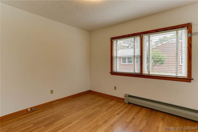 449 Martha Lee Dr, New Market, VA 23666 - empty room with a baseboard radiator, plenty of natural light, light wood finished floors, and baseboards