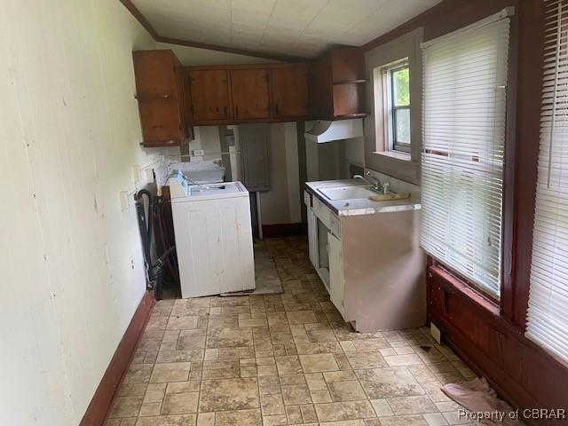 2784 Kings Creek Rd, Hayes, VA 23072 - kitchen featuring washer / dryer, lofted ceiling, a sink, light countertops, and stone finish flooring