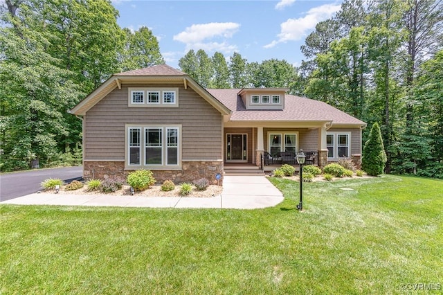 17231 Ivory Bill Ln, Chesterfield, VA 23838 - craftsman-style home featuring stone siding, covered porch, a front yard, and a shingled roof