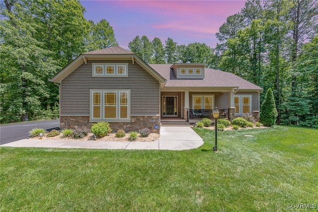 17231 Ivory Bill Ln, Chesterfield, VA 23838 - craftsman-style house with stone siding, a porch, a yard, and a shingled roof