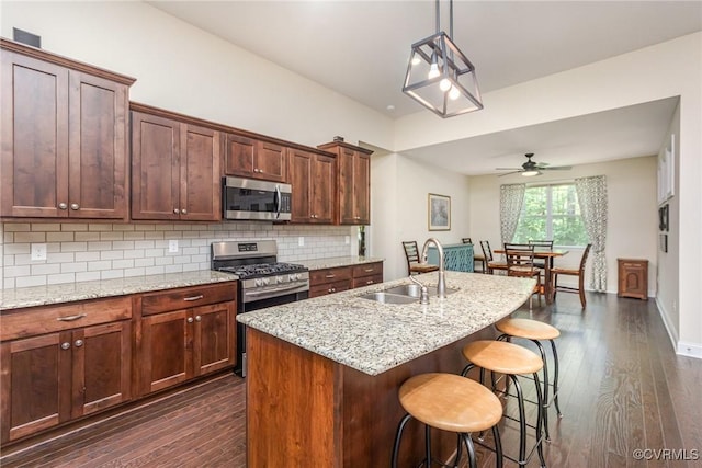 17231 Ivory Bill Ln, Chesterfield, VA 23838 - kitchen with stainless steel appliances, dark wood-style flooring, a sink, and decorative backsplash