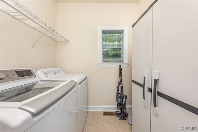 17231 Ivory Bill Ln, Chesterfield, VA 23838 - laundry room featuring washer and dryer, baseboards, and light tile patterned flooring