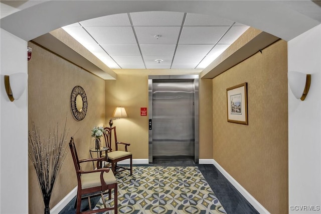 4250 Granby St Unit 105, Norfolk, VA 23504 - corridor featuring elevator, baseboards, a paneled ceiling, and a textured wall