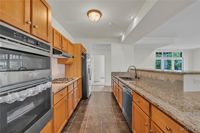4250 Granby St Unit 105, Norfolk, VA 23504 - kitchen featuring a sink, stainless steel appliances, light stone countertops, under cabinet range hood, and brown cabinetry