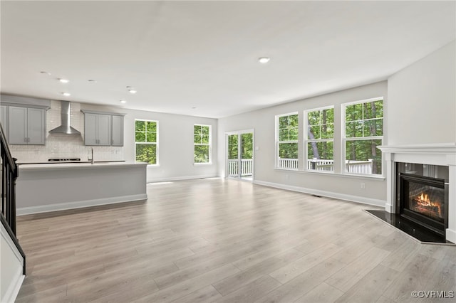 16831 Barmer Rd, Chesterfield, VA 23838 - unfurnished living room featuring a fireplace with flush hearth, light wood-style floors, baseboards, and recessed lighting