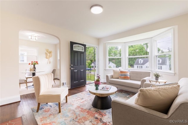 2214 Parkside Ave, Henrico, VA 23228 - living area with arched walkways, dark wood-style floors, and baseboards