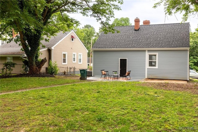 2214 Parkside Ave, Henrico, VA 23228 - rear view of property featuring a chimney, a patio, a lawn, and roof with shingles