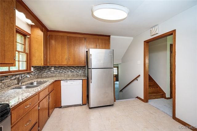 10216 Greglynn Rd, North Chesterfield, VA 23236 - kitchen featuring stainless steel appliances, a sink, brown cabinetry, and backsplash