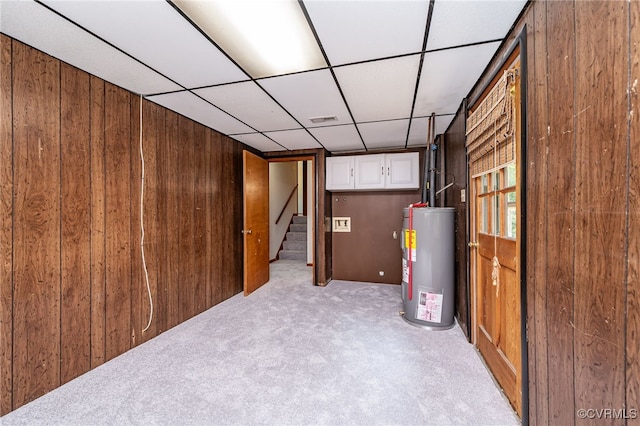 10216 Greglynn Rd, North Chesterfield, VA 23236 - basement featuring electric water heater, wood walls, light colored carpet, stairs, and a drop ceiling