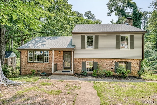 10216 Greglynn Rd, North Chesterfield, VA 23236 - tri-level home featuring a chimney, brick siding, roof with shingles, and a front yard