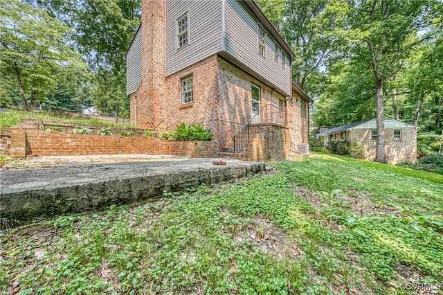 10216 Greglynn Rd, North Chesterfield, VA 23236 - view of side of property with a chimney, brick siding, and an outdoor structure