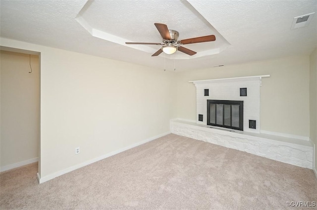 10486 Malboro Rd, Hanover, VA 23116 - unfurnished living room featuring carpet floors, a textured ceiling, a tray ceiling, ceiling fan, and a brick fireplace