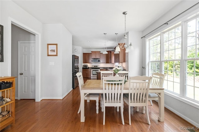 14300 Wallingham Loop, Midlothian, VA 23114 - dining space with light wood finished floors, baseboards, and a chandelier