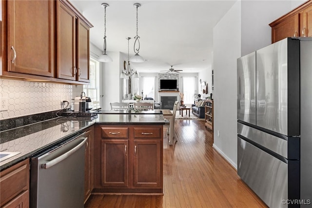 14300 Wallingham Loop, Midlothian, VA 23114 - kitchen featuring appliances with stainless steel finishes, ceiling fan, plenty of natural light, and a large fireplace