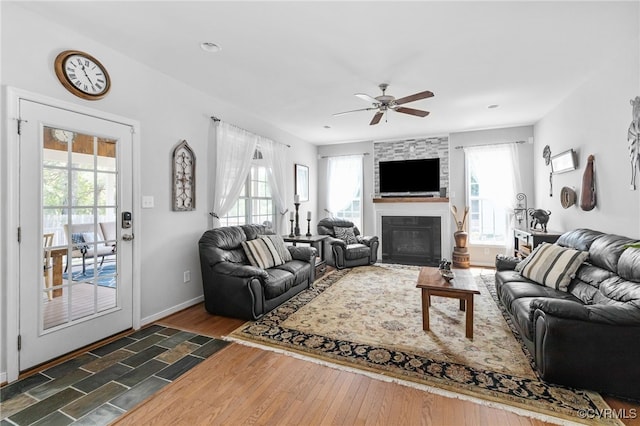 14300 Wallingham Loop, Midlothian, VA 23114 - living room featuring ceiling fan, a large fireplace, dark wood-type flooring, and baseboards