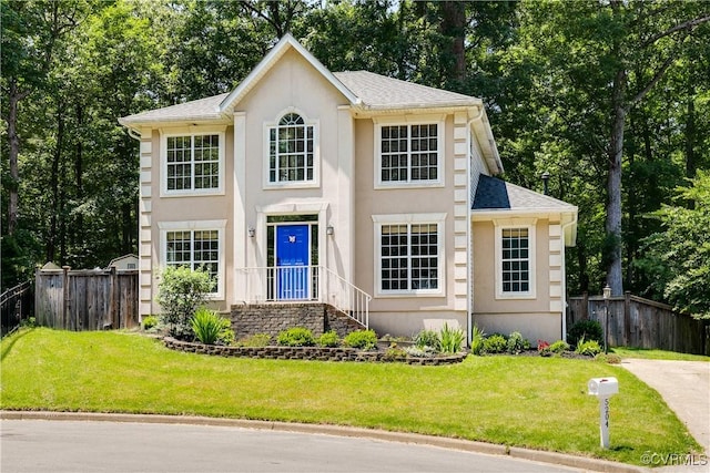 5204 Sylvan Ct, Richmond, VA 23225 - view of front of home featuring stucco siding, roof with shingles, and view of wooded area
