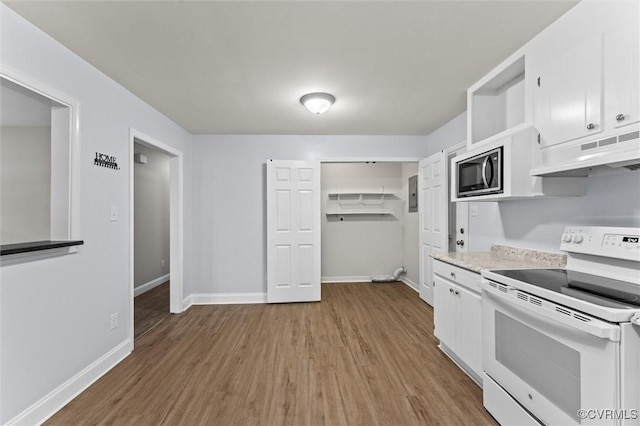 425 S 20th Ave, Hopewell, VA 23860 - kitchen featuring white electric range oven, under cabinet range hood, stainless steel microwave, light wood-type flooring, and white cabinets