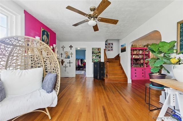 290 Circle Dr, Port Haywood, VA 23138 - sitting room with ceiling fan, a textured ceiling, wood finished floors, and stairs