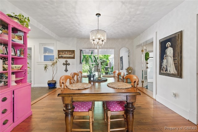 290 Circle Dr, Port Haywood, VA 23138 - dining area with a chandelier, wood-type flooring, and a textured ceiling