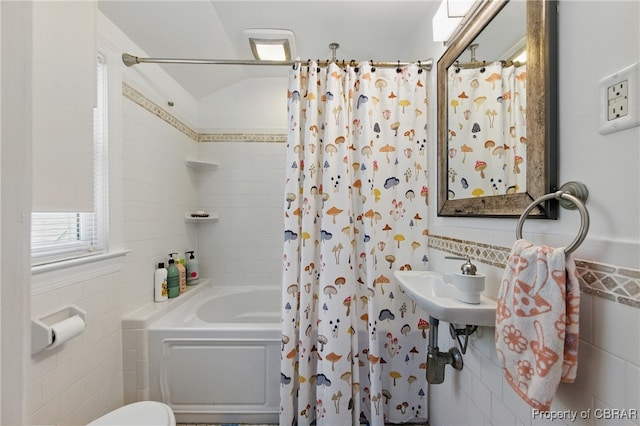 290 Circle Dr, Port Haywood, VA 23138 - bathroom featuring tile walls, shower / bath combo, and a wainscoted wall