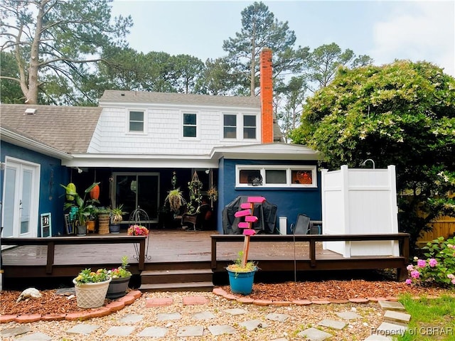 290 Circle Dr, Port Haywood, VA 23138 - rear view of property featuring a wooden deck, a chimney, and roof with shingles