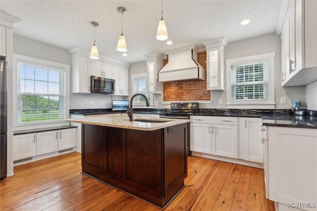 29898 The Trl, Shacklefords, VA 23110 - kitchen with appliances with stainless steel finishes, custom range hood, a sink, white cabinets, and recessed lighting