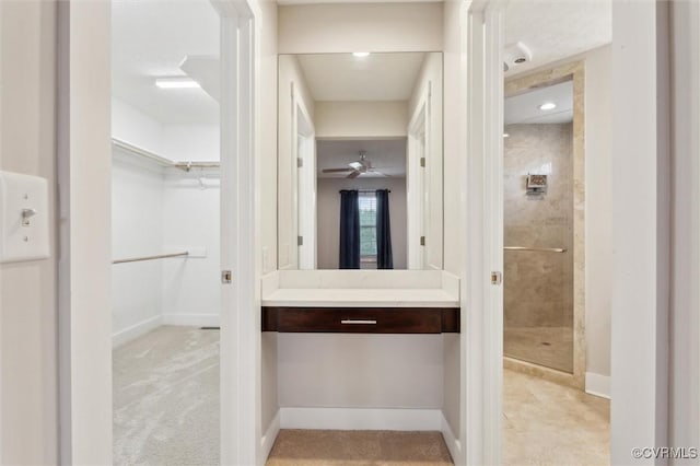 29898 The Trl, Shacklefords, VA 23110 - bathroom featuring tiled shower, a walk in closet, vanity, and baseboards