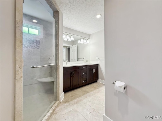 29898 The Trl, Shacklefords, VA 23110 - full bathroom featuring double vanity, a stall shower, a textured ceiling, baseboards, and a chandelier