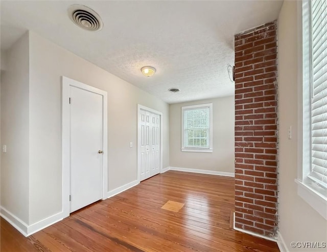 29898 The Trl, Shacklefords, VA 23110 - unfurnished room with hardwood / wood-style flooring, plenty of natural light, baseboards, and a textured ceiling