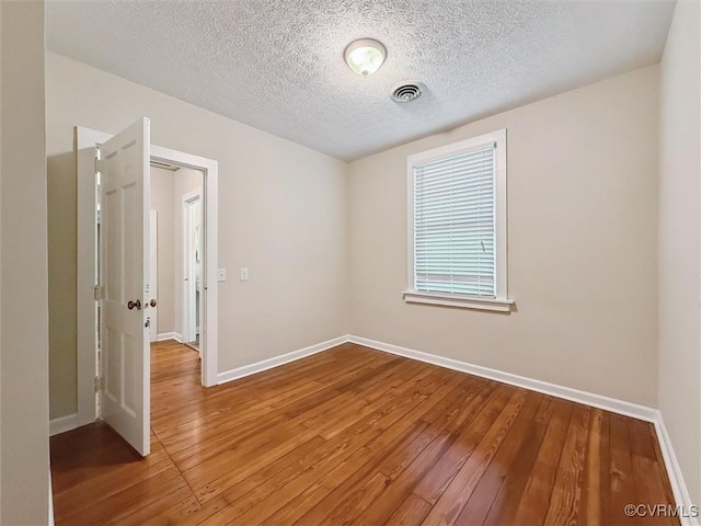 29898 The Trl, Shacklefords, VA 23110 - unfurnished room with hardwood / wood-style floors, baseboards, and a textured ceiling