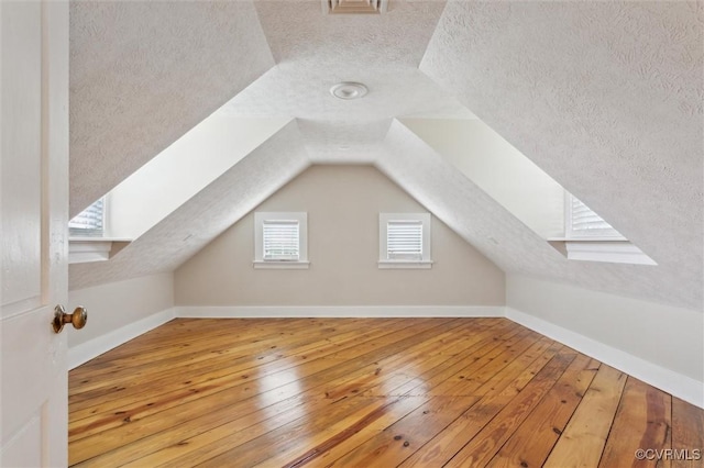29898 The Trl, Shacklefords, VA 23110 - bonus room with a textured ceiling, hardwood / wood-style flooring, lofted ceiling, and baseboards