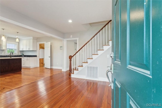 29898 The Trl, Shacklefords, VA 23110 - entryway with light wood-type flooring, stairway, baseboards, and recessed lighting