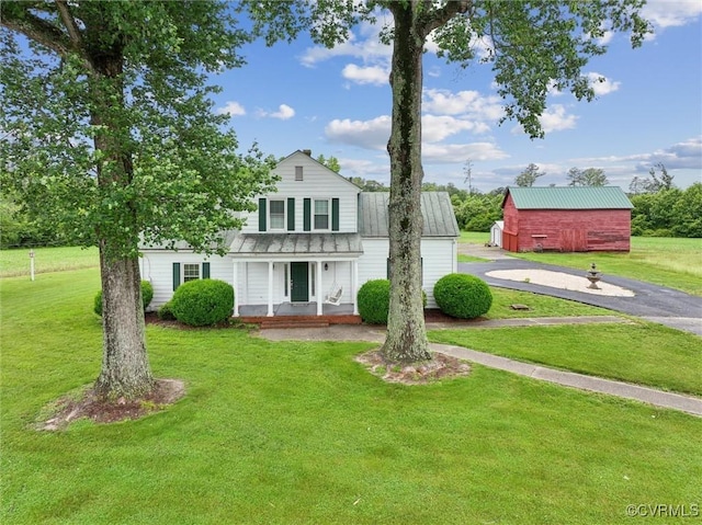 29898 The Trl, Shacklefords, VA 23110 - traditional-style house featuring covered porch, a front yard, and metal roof