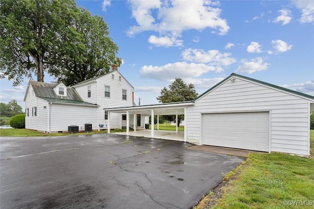29898 The Trl, Shacklefords, VA 23110 - view of front of home featuring cooling unit, asphalt driveway, and an outbuilding