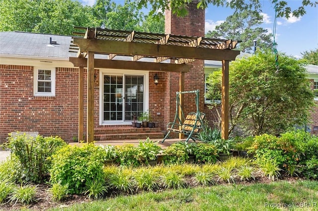 1 Beacon Cir, Hampton, VA 23664 - view of exterior entry with a chimney, brick siding, and a pergola